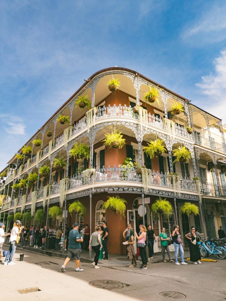 A lively street scene in the French Quarter showcasing ornate balconies and vibrant décor.